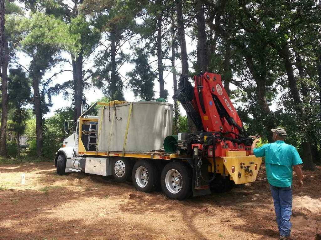 Crane truck lowering a new septic tank on a Godley TX rural property — Godley Septic install in progress